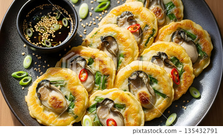 Hot Pan Fried Oyster Pancakes with Scallions and Red Chili. Golden Korean Seafood Jeon Platter Styled for Food Blogs, Restaurant Menus and High Resolution Stock Photography 135432791