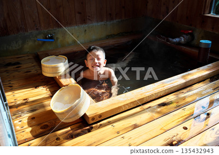 Boy bathing in hot spring Boy bathing in hot spring 135432943