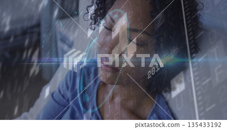 Lying woman wearing blue shirt receiving holographic scan at clinical lab, with notebook nearby 135433192