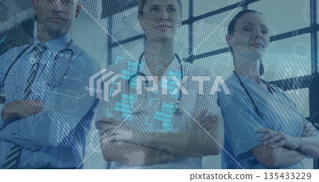 Standing medical team in scrubs with stethoscopes crossing arms in tech corridor with data overlay Standing medical team in scrubs with stethoscopes crossing arms in tech corridor with data overlay 135433229