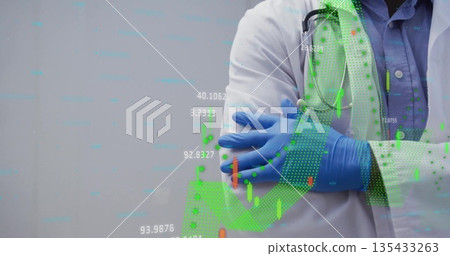 Standing doctor crossing arms at lab, with stethoscope, blue gloves, lab coat, charts, copy space 135433263