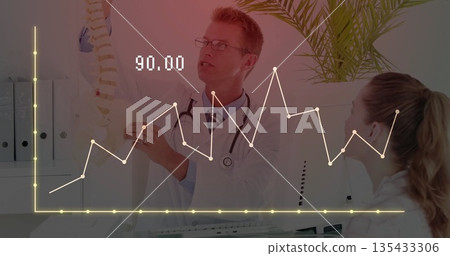 Explaining anatomy, doctor pointing at spine model beside patient in clinic, with chart overlay Explaining anatomy, doctor pointing at spine model beside patient in clinic, with chart overlay 135433306