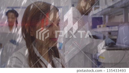 Researcher wearing lab coat and gloves viewing data overlay in laboratory, with pipettes 135433493