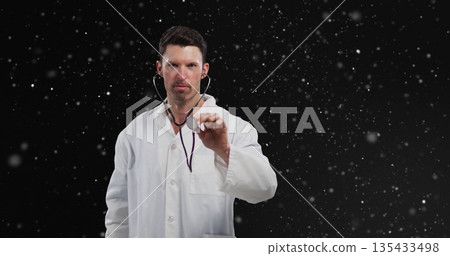 Extending adult doctor wearing lab coat presenting stethoscope in studio, with particle backdrop Extending adult doctor wearing lab coat presenting stethoscope in studio, with particle backdrop 135433498