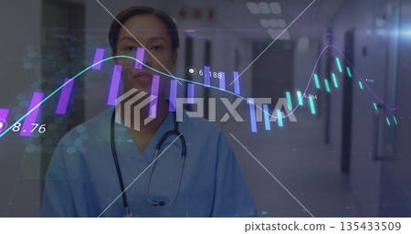 Standing Hispanic nurse monitoring digital data in hospital corridor, with stethoscope and charts Standing Hispanic nurse monitoring digital data in hospital corridor, with stethoscope and charts 135433509
