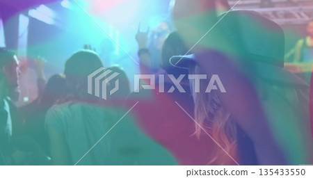 Raising fan wearing wide-brimmed hat making rock sign in light beams at concert venue, copy space Raising fan wearing wide-brimmed hat making rock sign in light beams at concert venue, copy space 135433550