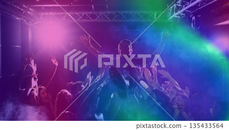 Crowd-surfing male fan riding over cheering crowd inside club, with stage lights and metal truss Crowd-surfing male fan riding over cheering crowd inside club, with stage lights and metal truss 135433564