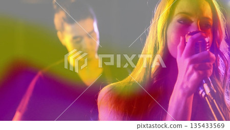 Female singer performing on stage with microphone, electric guitar, spotlights and haze, copy space Female singer performing on stage with microphone, electric guitar, spotlights and haze, copy space 135433569