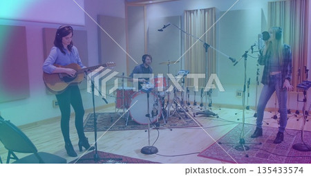 Playing acoustic guitar, drummer drumming and vocalist singing in live room with drums, microphones Playing acoustic guitar, drummer drumming and vocalist singing in live room with drums, microphones 135433574