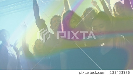 Dancing six friends cheering under club lights, with overhead lighting rig and haze machine effects Dancing six friends cheering under club lights, with overhead lighting rig and haze machine effects 135433586