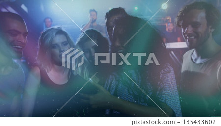 Smiling group of friends taking selfie at music venue, with smartphone and stage lights Smiling group of friends taking selfie at music venue, with smartphone and stage lights 135433602