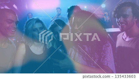 Gathering group of six friends viewing smartphone at club dance floor, with stage mic and lights Gathering group of six friends viewing smartphone at club dance floor, with stage mic and lights 135433603