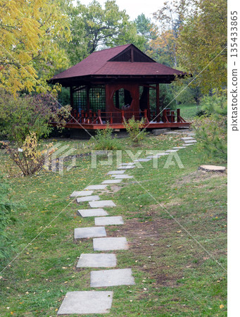 Winding Stone Path Among Tall Pine Trees In Autumn Garden Winding Stone Path Among Tall Pine Trees In Autumn Garden 135433865