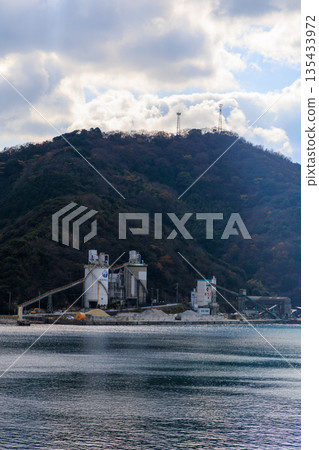 A harbor scene surrounded by the calm sea and mountains of Yawatahama Port in Ehime 135433972