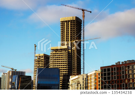 Dynamic urban landscape highlighted by developing structures and gleaming exteriors Dynamic urban landscape highlighted by developing structures and gleaming exteriors 135434238