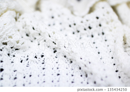 Cozy textured crochet, Closeup of warm crochet throw with detailed fiberwork and gentle folds Cozy textured crochet, Closeup of warm crochet throw with detailed fiberwork and gentle folds 135434250