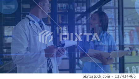Reviewing doctor in coat discussing with nurse in corridor, clipboard displaying digital overlays Reviewing doctor in coat discussing with nurse in corridor, clipboard displaying digital overlays 135434466