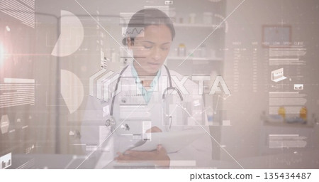 Reviewing digital charts female doctor using tablet in clinic, with stethoscope and medicine 135434487