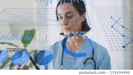 Reviewing data on tablet, nurse in blue scrubs and stethoscope in clinic, digital charts overlay Reviewing data on tablet, nurse in blue scrubs and stethoscope in clinic, digital charts overlay 135434490