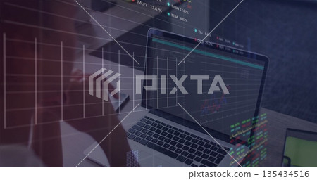 Studying financial charts on laptop, mid adult woman holding eyeglasses on wooden desk, copy space 135434516