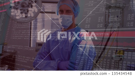 Standing cross-armed surgeon wearing gown in procedure room, with surgical light and code overlay Standing cross-armed surgeon wearing gown in procedure room, with surgical light and code overlay 135434548