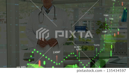 Reviewing senior physician analyzing floating digital graphs in medical office, with stethoscope 135434597
