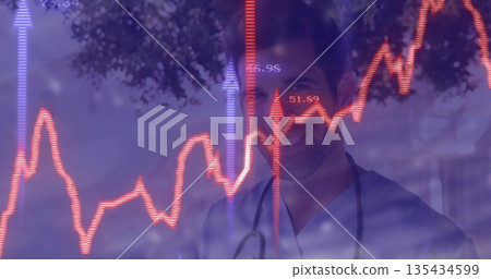 Standing male doctor wearing blue scrubs and stethoscope at hospital, with red-purple line graphs Standing male doctor wearing blue scrubs and stethoscope at hospital, with red-purple line graphs 135434599