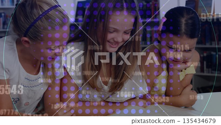 Leaning three girls reading open book at school library, with wooden bookshelves and purple overlay Leaning three girls reading open book at school library, with wooden bookshelves and purple overlay 135434679