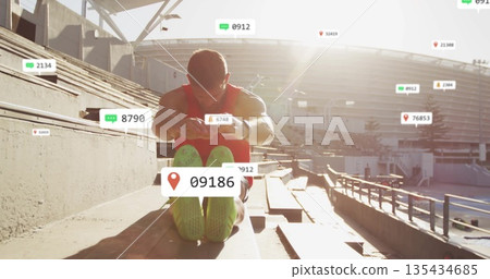Stretching man in red tank reaching toward feet on stadium bleachers, with floating metrics icons Stretching man in red tank reaching toward feet on stadium bleachers, with floating metrics icons 135434685