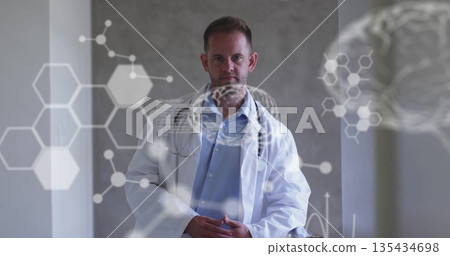 Standing male doctor wearing lab coat and stethoscope at medical lab, showing digital overlays Standing male doctor wearing lab coat and stethoscope at medical lab, showing digital overlays 135434698