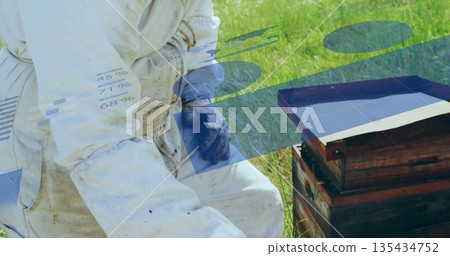 Kneeling beekeeper inspecting hive box in meadow wearing protective suit and gloves, copy space Kneeling beekeeper inspecting hive box in meadow wearing protective suit and gloves, copy space 135434752