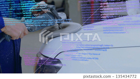 Polishing auto detailer buffing car fender in workshop, with electric buffer and code overlay 135434772