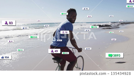 Riding man pedaling bicycle with drop handlebars along wet sand shore, with social media overlays Riding man pedaling bicycle with drop handlebars along wet sand shore, with social media overlays 135434928