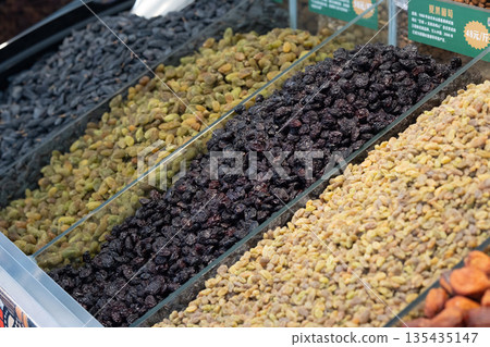 Colorful dried fruits and nuts line the market stalls, food culture of Central Asia and the Silk Road Colorful dried fruits and nuts line the market stalls, food culture of Central Asia and the Silk Road 135435147