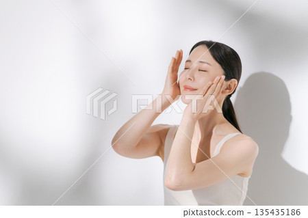A young woman doing skin care 135435186