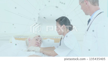 Asian doctor in white coat examining senior patient in hospital bed, with stethoscope and blanket Asian doctor in white coat examining senior patient in hospital bed, with stethoscope and blanket 135435405