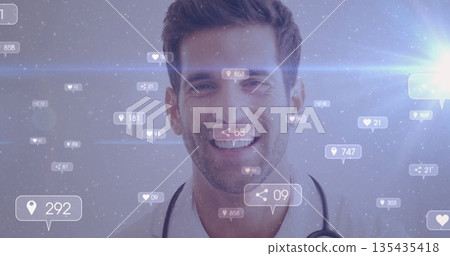 Smiling adult male doctor wearing white coat and stethoscope in studio, with floating digital icons 135435418