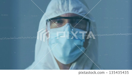 Standing male wearing coverall with hood, goggles and surgical mask in lab, with data graph overlay 135435435