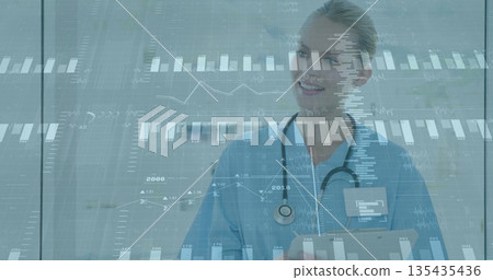 Reviewing nurse in blue scrubs presenting digital data in clinic room, clipboard, stethoscope 135435436