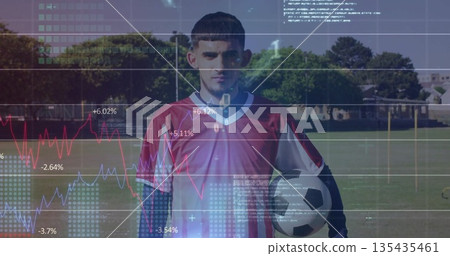Displaying male player in red jersey holding ball on grassy pitch, with digital line graphs, code Displaying male player in red jersey holding ball on grassy pitch, with digital line graphs, code 135435461