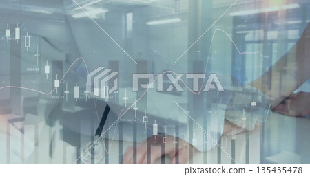 Doctor with stethoscope typing and jotting at desk with laptop and clipboard financial charts 135435478