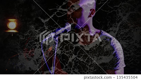 Singing performer wearing light shirt holding microphone stand under spotlight on stage, copy space Singing performer wearing light shirt holding microphone stand under spotlight on stage, copy space 135435504