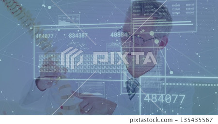 Holding spinal column model, mature doctor in lab coat analyzing holographic data panels in clinic 135435567