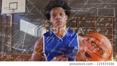 Standing athlete in blue jersey holding basketball labeled SPORTS on school gym court, math overlay Standing athlete in blue jersey holding basketball labeled SPORTS on school gym court, math overlay 135435580