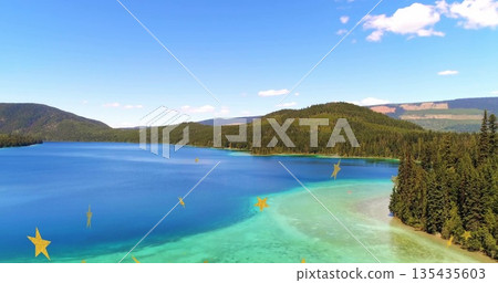 Showing turquoise lake shimmering beside pine forest and distant mountains, with golden star motifs Showing turquoise lake shimmering beside pine forest and distant mountains, with golden star motifs 135435603