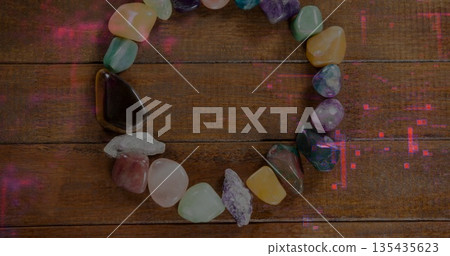 Displaying ring of polished semi-precious stones on wooden planks, with vivid hues Displaying ring of polished semi-precious stones on wooden planks, with vivid hues 135435623
