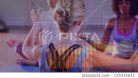 Woman wearing blue sportswear extending arms in yoga studio, with yoga mats and data overlays 135435643