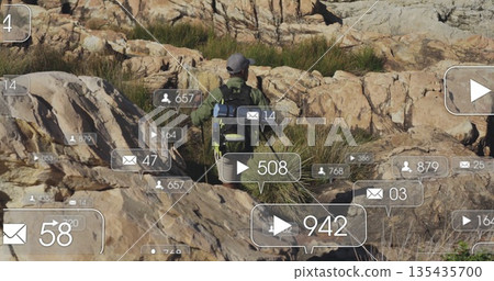 Hiking male hiker navigating hill, wearing jacket and cap with backpack and social media icons 135435700