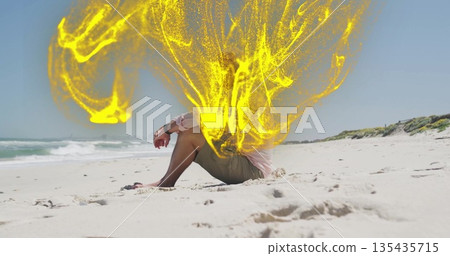 Sitting senior male wearing pink shirt on beach, with yellow energy effect, wristwatch, copy space 135435715