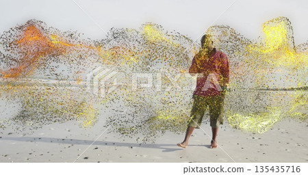 Man in red top olive pants holding smartphone on beach, with swirling particles, copy space Man in red top olive pants holding smartphone on beach, with swirling particles, copy space 135435716
